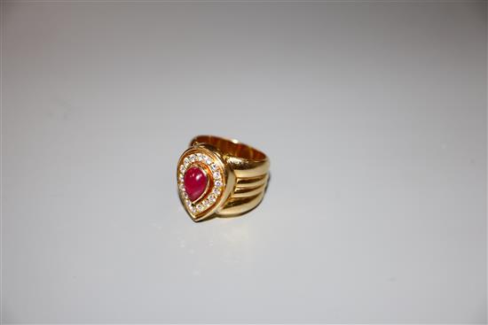 A modern 750 yellow metal, pear shaped cabochon ruby and diamond set dress ring, size N, gross 17.2 grams.